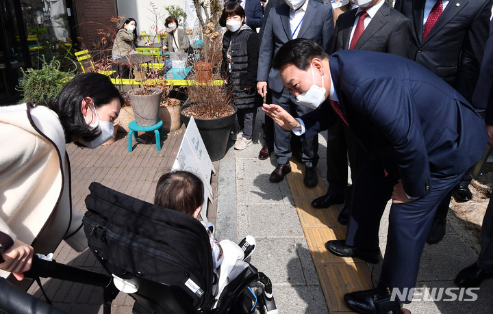 [서울=뉴시스] 국회사진기자단 = 윤석열 대통령 당선인이 지난 3월16일 오후 서울 종로구 통의동에 위치한 한 식당에서 점심 식사를 마친 후 참모진들과 함께 산책을 하며 어린이와 인사를 하고 있다. 2022.03.16. photo@newsis.com