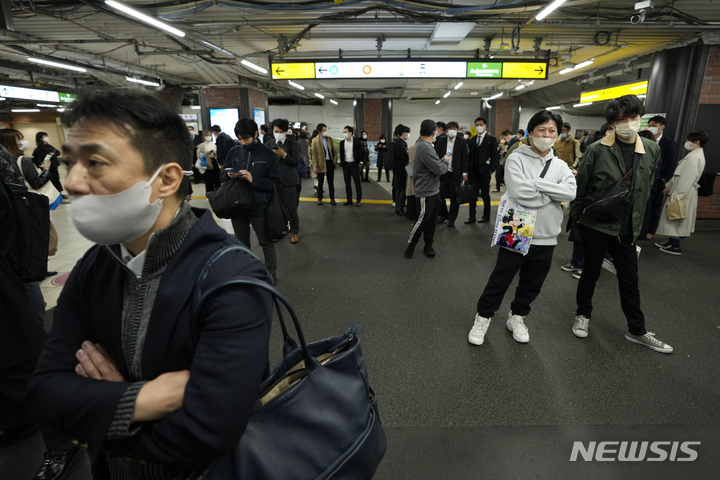 [도쿄=AP/뉴시스]16일 일본 도쿄의 한 기차역에서 시민들이 열차 운행 재개를 기다리고 있다. 2022.3.17.