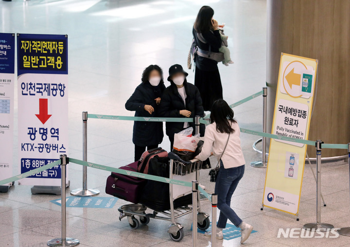 [인천공항=뉴시스] 홍찬선 기자 = 정부가 코로나19 예방접종을 실시한 해외 입국자에 대해 7일간의 자가격리를 면제해주기로한 21일 인천공항 제1여객터미널 입국장에서 승객들이 가족과 재회하고 있다. 2022.03.21. xconfind@newsis.com