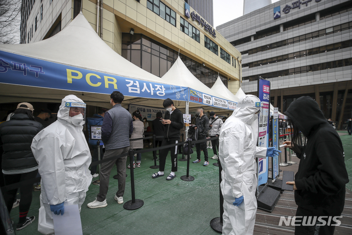 [서울=뉴시스] 정병혁 기자 = 국내 코로나19 누적 확진자가 1000만명을 넘어선 23일 오전 서울 송파구 보건소에 설치된 선별진료소를 찾은 시민들이 검사를 받기 위해 줄 서 있다. 2022.03.23. jhope@newsis.com