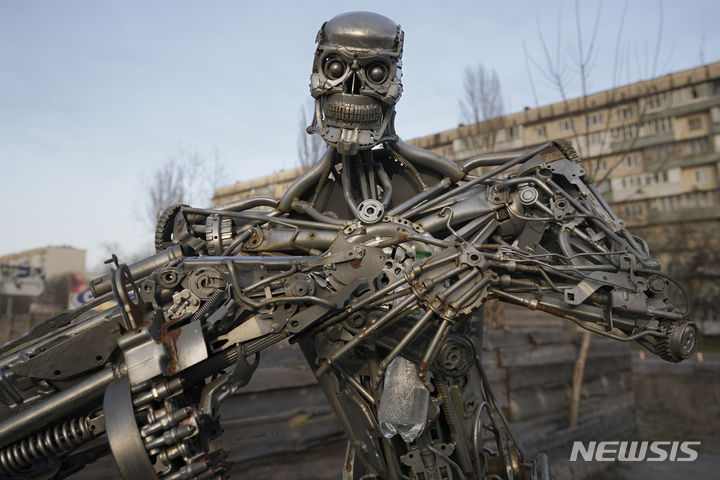 [키이우=AP/뉴시스] 25일(현지시간) 우크라이나 키이우의 한 검문소 인근에 자동차 변속기 부품으로 만든 영화 캐릭터 '터미네이터'가 세워져 있다. 2022.03.26. 