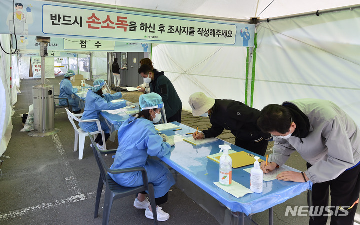 [대구=뉴시스] 이무열 기자 = 29일 오전 대구 수성구 대구스타디움 제3주차장에 마련된 임시선별검사소에서 시민들이 코로나19 진단검사를 받기 위해 조사지를 작성하고 있다. 2022.03.29. lmy@newsis.com