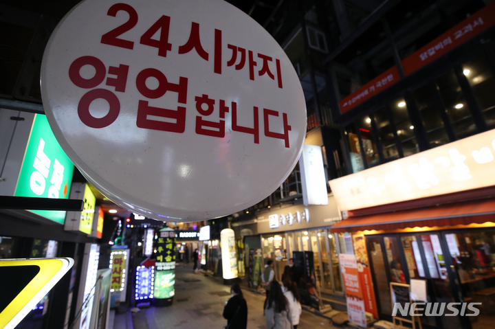 [서울=뉴시스] 조성우 기자 = 사회적 거리두기 완화로 사적 모임 10인, 영업시간 밤 12시까지가 적용된 4일 오후 서울 종로구 젊음의 거리의 한 식당에 24시까지 영업 간판이 설치돼 있다. 2022.04.04. xconfind@newsis.com