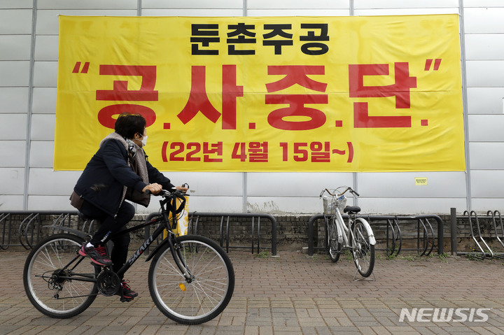 [서울=뉴시스] 최동준 기자 = 둔촌주공 재건축 사업이 공사비 증액 문제를 두고 조합과 시공건설사들 간 갈등이 이어지고 있는 14일 서울 강동구 둔촌주공 재건축 현장에 공사중단 현수막이 걸려 있다. 2022.04.14. photocdj@newsis.com