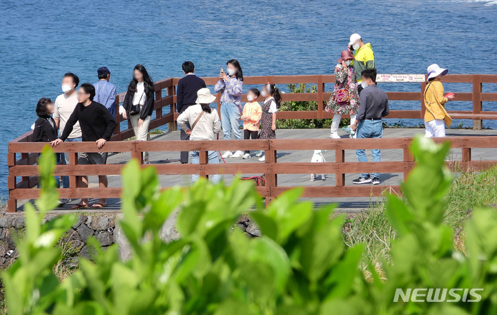 [제주=뉴시스] 우장호 기자 = 실외 마스크 의무 착용이 해제된 2일 오후 제주 시내권 대표적인 관광지인 용두암에 관광객들이 찾아와 즐거운 시간을 보내고 있다. 2022.05.02. woo1223@newsis.com