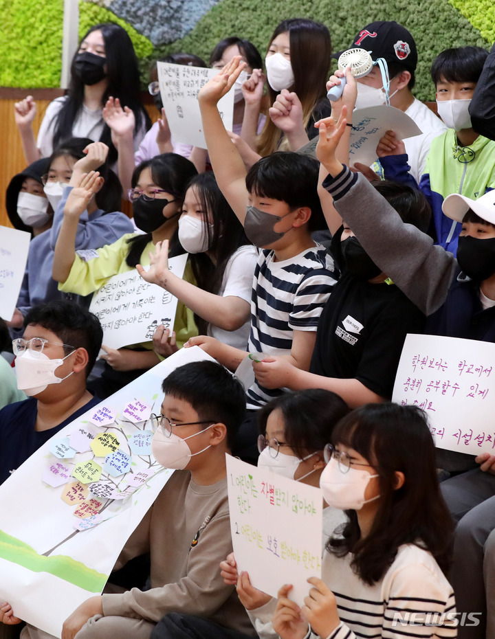 [서울=뉴시스] 추상철 기자 = 어린이날 100주년 기념 공개수업이 열린 4일 오전 서울 동작구 보라매초등학교에서 6학년 학생들이 직접 만든 '어린이헌장'을 들고 기념촬영을 하고 있다. 한국교원단체총연합회는 오는 6일까지 어린이날 100주년 기념 계기 수업 캠페인을 진행하고 있다. 2022.05.04. scchoo@newsis.com