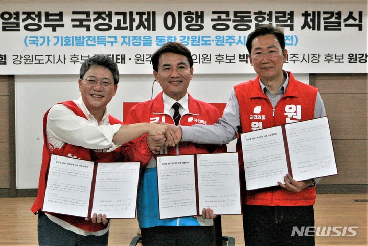[원주=뉴시스] 이덕화 기자 = 13일 국민의힘 김진태 강원도지사 후보, 박정하 원주갑 국회의원 후보, 원강수 원주시장 후보가 원주시청 브리핑룸에서 부론산업단지 등을 '기회발전특구'로 지정하기 위해 적극 협력한다는 '윤석열 정부 국정과제 이행 공동협력 체결식'을 가진 가운데 세 후보가 협약서를 들고 약속 이행을 다짐하고 있다. 2022.05.13. wonder8768@newsis.com
