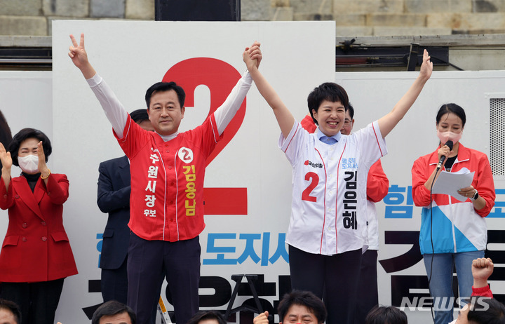 [수원=뉴시스] 국회사진기자단 = 김은혜 국민의힘 경기도지사 후보가 19일 경기도 수원시 팔달문시장 앞에서 후보 출정식을 열고 수원시장 김용남 후보와 만세하고 있다. 2022.05.19. photo@newsis.com