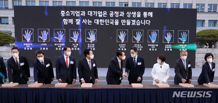 [서울=뉴시스] 전신 기자 = 윤석열 대통령이 25일 서울 용산 대통령실 청사 앞 잔디광장에서 열린 2022 대한민국 중소기업인대회에서 대·중소기업 간 공정과 상생을 통한 신동반성장을 다짐하는 핸드프린팅 퍼포먼스를 하고 있다. 왼쪽부터 구광모 LG그룹 회장, 강삼권 벤처기업협회장, 최태원 SK그룹 회장, 김기문 중소기업중앙회장, 윤 대통령, 이재용 삼성전자 부회장, 이정한 한국여성경제인협회장, 정의선 현대자동차그룹 회장, 오세희 소상공인연합회장. 2022.05.25. photo1006@newsis.com
