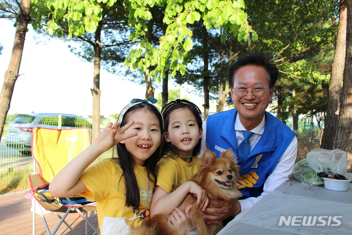 [청주=뉴시스] 임선우 기자 = 더불어민주당 송재봉 청주시장 후보가 28일 문암생태공원에서 아이들과 사진을 찍고 있다. 이용객들에게 불편 사항을 청취한 송 후보는 캠핑장 확충을 약속했다. 2022.05.28. photo@newsis.com