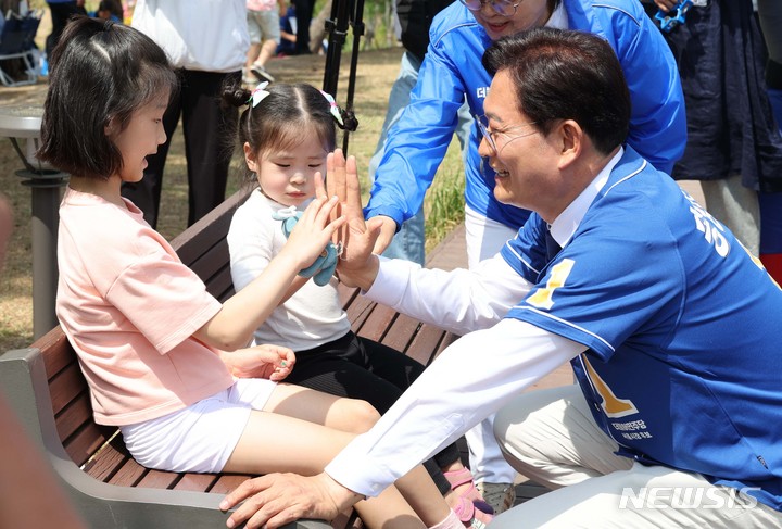 [서울=뉴시스] 국회사진기자단 = 송영길 더불어민주당 서울시장 후보가 29일 서울 강북구 북서울꿈의숲에서 유세 중 어린이들과 인사하고 있다. 2022.05.29. photo@newsis.com