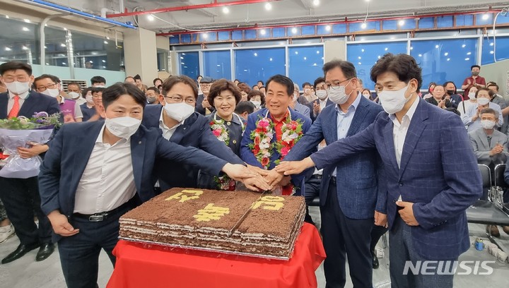 [양산=뉴시스] 안지율 기자 = 제8회 전국동시 지방선거일인 2일 국민의힘 나동연 경남 양산시장 후보가 자신의 선거캠프에서 당선이 확실해지자 부인 정희자 여사, 지지자들과 함께 축하 떡을 자르고 있다. 2022.06.02. alk9935@newsis.com