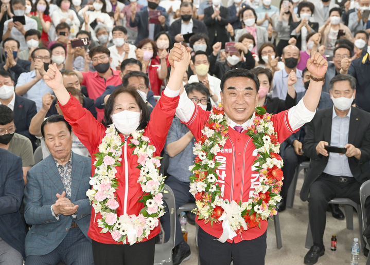 [울산=뉴시스] 배병수 기자 = 제8회 전국동시지방선거에서 국민의힘 김두겸 울산시장 후보가 1일 자신의 선거사무소에서 당선이 확실시 되자 부인 양순이씨와 손을 맞잡고 환호하고 있다. 2022.06.02. bbs@newsis.com