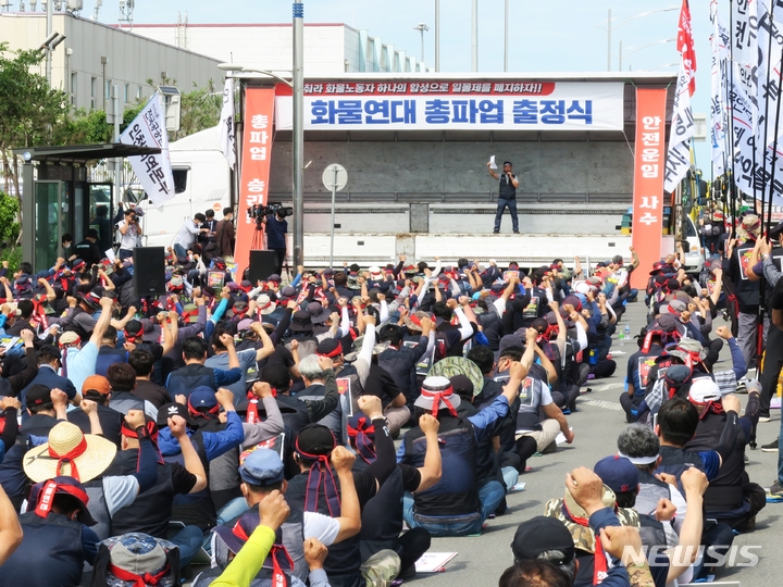 [인천=뉴시스] 김동영 기자 = 민주노총 공공운수노조 화물연대본부가 안전 운임 일몰제 폐지를 요구하며 총파업에 돌입한 7일 오전 인천 연수구 인천 신항 컨테이너 터미널 앞에서 열린 총파업 출정식에서 인천지역본부 조합원들이 구호를 외치고 있다. 2022.06.07. dy0121@newsis.com 