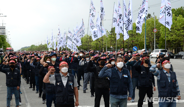 [군산=뉴시스] 김얼 기자 = 민주노총 공공운수노조 화물연대본부 관계자들이 7일 전북 군산시 군산항 5부두 앞에서 화물연대 총파업 출정식을 열고 구호를 외치고 있다. 2022.06.07. pmkeul@newsis.com