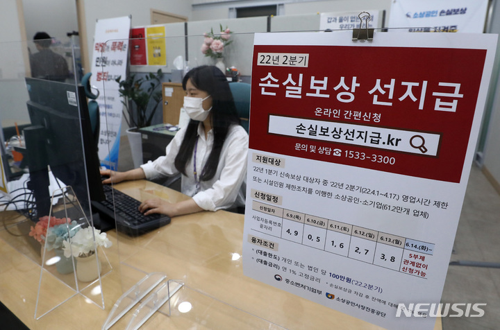 [서울=뉴시스] 이영환 기자 = 올해 2분기(4~6월) 손실보상 선지급 신청이 시작된 9일 오전 서울 종로구 소상공인시장진흥공단 서울중부센터에서 직원이 업무를 보고 있다. 선지급 금액은 100만원이며 이날 오전 9시부터 공휴일·주말 관계 없이 '손실보상선지급.kr'을 통해 신청할 수 있다. 동시접속 분산을 위해 첫 5일간은 사업자등록번호 끝자리를 기준으로 5부제가 시행되며 이후에는 관계 없이 신청이 가능하다.2022.06.09. 20hwan@newsis.com