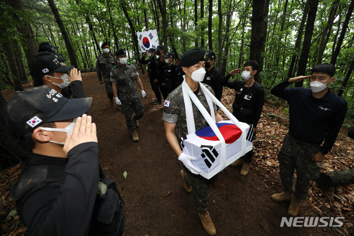 [포천=뉴시스] 백동현 기자 = 지난 16일 경기 포천시 소흘읍 일대 야산에서 국방부 유해발굴감식단과 8기동사단 진호대대 대원들이 수습한 유해를 봉송하고 있다. 2022.06.24. livertrent@newsis.com