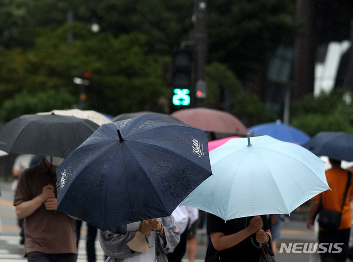 [서울=뉴시스] 추상철 기자 = 소강상태를 보이던 장맛비가 내린 29일 오후 서울 중구 세종대로 사거리에서 우산을 쓴 시민이 발걸음을 재촉하고 있다. 2022.06.29. scchoo@newsis.com