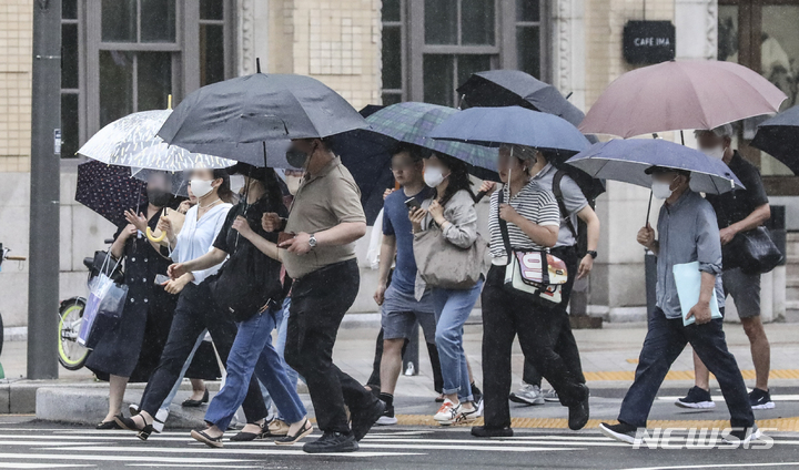 [서울=뉴시스] 장맛비가 내리는 지난 29일 오후 서울 중구 세종로사거리에서 시민들이 발걸음을 재촉하고 있다. 2022.06.30. (사진 = 뉴시스DB) photo@newsis.com