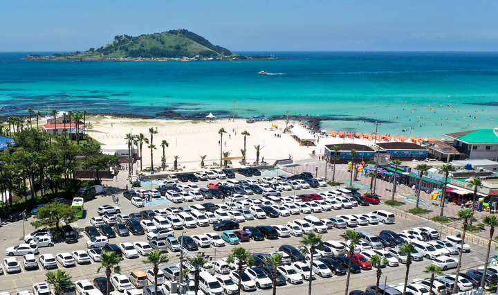 [제주=뉴시스] 우장호 기자 = 제주 도내 12개 지정 해수욕장 개장 첫날인 1일 오후 제주시 한림읍 협재해수욕장 주차장이 피서객들이 타고 온 차량들로 가득차 있다. 2022.07.01. woo1223@newsis.com