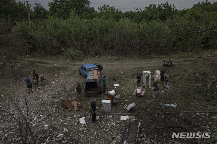 [차시우 야르=AP/뉴시스] 10일(현지시간) 우크라이나 동부 도네츠크주의 차시우 야르의 아파트 단지가 러시아군의 로켓 공격을 받은 후 주민들이 세간살이 등을 꺼내고 있다. 2022.07.11.
