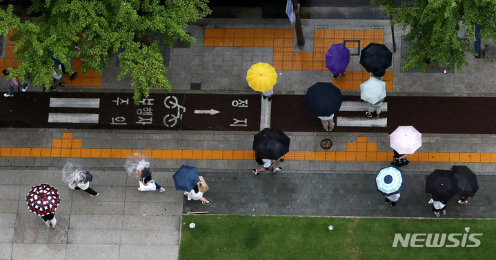 [서울=뉴시스] 추상철 기자 = 무더위를 시켜준 비가 내린 지난달 31일 오후 서울 도심에서 우산을 쓴 시민들이 발걸음을 옮기고 있다. 2022.07.31. scchoo@newsis.com