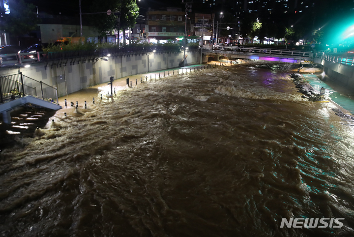 [서울=뉴시스] 고승민 기자 = 서울과 경기북부 등 수도권에 폭우가 내린 9일 새벽 서울 도림천이 산책로까지 범람해 거세게 흐르고 있다. 2022.08.09. kkssmm99@newsis.com
