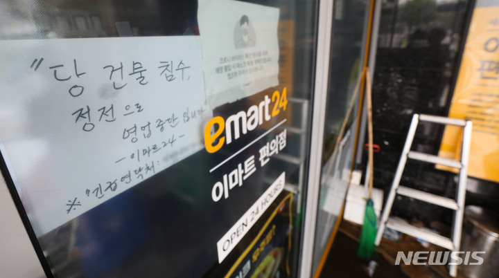 [서울=뉴시스] 권창회 기자 = 기록적인 폭우가 계속되고 있는 9일 오전 서울 강남구 대치역 인근 건물에 정전으로 인한 업무불가 안내문이 붙어있다. 2022.08.09. kch0523@newsis.com