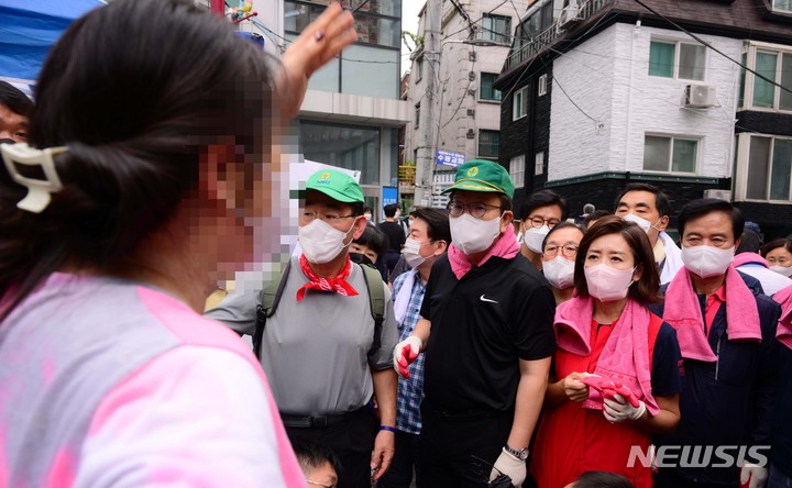 [서울=뉴시스] 국회사진기자단 = 11일 오전 서울 동작구 사당 2동 주민센터앞에서 한 시민이 수해복구 자원봉사를 하기 위해 현장에 모인 국민의힘 주호영 비상대책위원장과 권성동 원내대표에게 길을 막고 있다며 항의를 하고 있다. 2022.08.11. photo@newsis.com