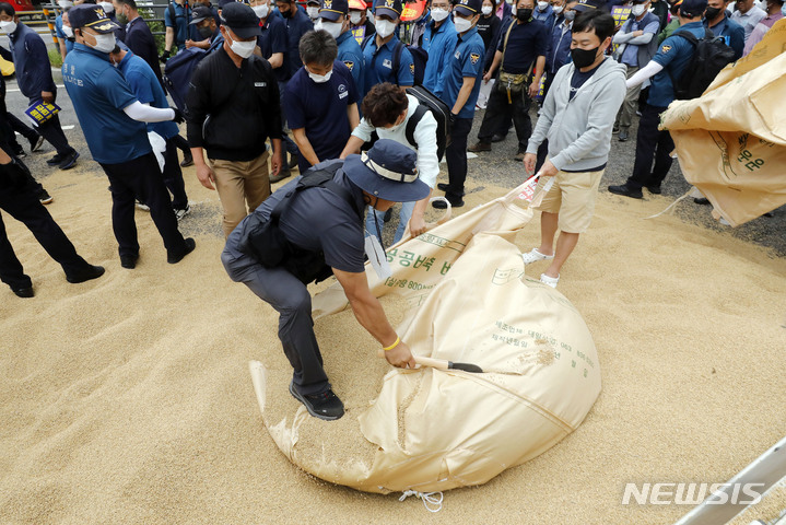 [서울=뉴시스] 최동준 기자 = 한국후계농업경영인중앙연합회 등 주요 농민 단체가 29일 서울 용산구 서울역 인근에서 농가경영 불안 해소 대책 마련 촉구 농민 총궐기를 마치고 정부 대책에 항의하며 쌀을 버리고 있다. 2022.08.29. photocdj@newsis.com