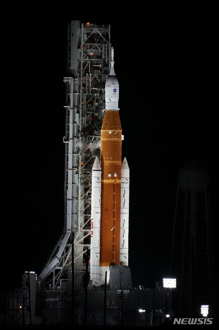 NASA's new moon rocket sits on Launch Pad 39-B hours before liftoff Monday, Aug. 29, 2022, in Cape Canaveral, Fla. This is scheduled to be the first flight of NASA's 21st-century moon-exploration program, named Artemis after Apollo's mythological twin sister. (AP Photo/Chris O'Meara)