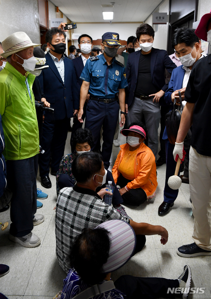 [광주=뉴시스] 이영주 기자 = 광주 광산구 양동 반려동물 화장장 건축 심의가 열린 22일 오후 광주 광산구청 2층 열린민원실 앞 복도에서 광산구 삼도동 주민자치위원회 등 주민들이 점거 시위를 하고 있다. 2022.09.22. leeyj2578@newsis.com