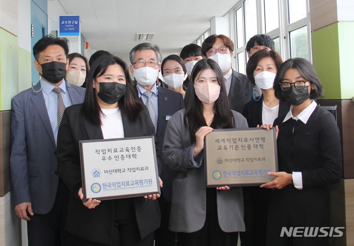 [창원=뉴시스] 홍정명 기자= 마산대학교 이학은 총장, 작업치료과 안태규 학과장 등이 28일 작업치료과 입구에서 한국작업치료교육평가원에서 보내온 세계작업치료사연맹 교육기준 인증 대학 및 우수 인증대학 현판을 들고 기념촬영을 하고 있다.(사진=마산대 제공) 2022.09.29. photo@newsis.com