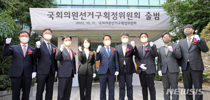 [서울=뉴시스] 김금보 기자 = 11일 오전 서울 관악구 중앙선거관리위원회 관악청사에서 열린 '제22대 국회의원선거 선거구획정위원회 출범식'에 참석한 송봉섭 위원장과 위원들이 현판식을 마치고 기념촬영 하고 있다. 국회의원선거구획정위원회는 이날 제1차 위원회의를 열고 송봉섭 중앙선관위 사무차장을 위원장으로 호선하고 활동에 들어갔다. 2022.10.11. kgb@newsis.com