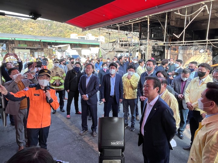 [대구=뉴시스]국민의힘 대구지역 국회의원들이 29일 오전 대형 화재가 발생한 대구시 북구 매천동 농수산물도매시장을 찾아 소방당국 관계자로부터 피해상황을 보고받고 있다. 사진 앞쪽 뒷짐을 진 사람은 김용판 대구시당 위원장이다(사진=국민의힘 대구시당 제공) 2022.10.29 photo@newsis.com  *재판매 및 DB 금지