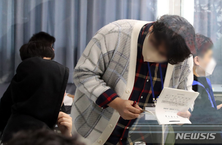[부산=뉴시스] 하경민 기자 = 2023학년도 대학수학능력시험일이었던 2022년 11월17일 부산 남구 대연고등학교에서 감독관이 수험생들의 신원을 확인하고 있는 모습. (사진=공동취재단) 2022.11.17. yulnetphoto@newsis.com