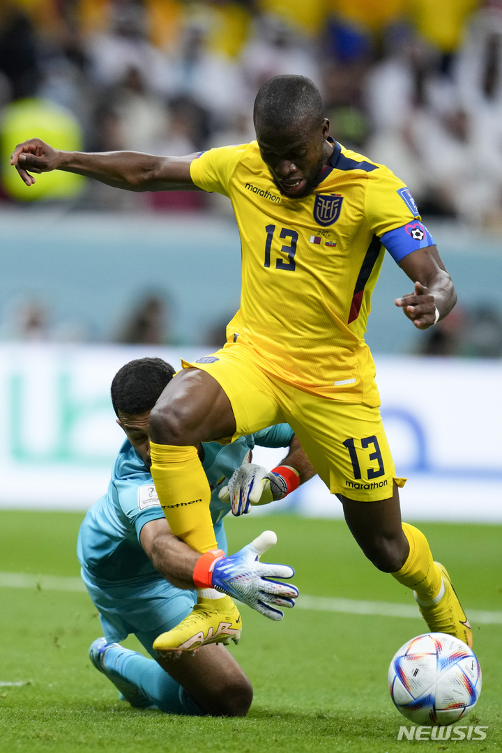 Qatar's goalkeeper Saad Al Sheeb fouls Ecuador's Enner Valencia during a World Cup group A soccer match at the Al Bayt Stadium in Al Khor , Qatar, Sunday, Nov. 20, 2022. (AP Photo/Manu Fernandez)