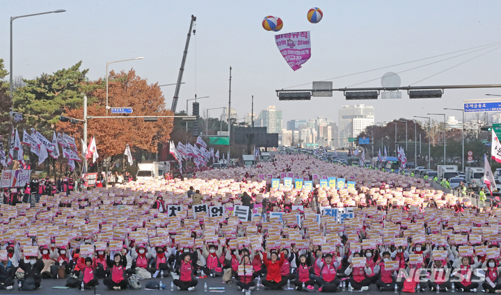 [서울=뉴시스] 김금보 기자 = 민주노총 서비스연맹 전국학교비정규직노동조합 조합원들이 25일 오후 서울 영등포구 여의대로에서 열린 '전국학교비정규직노동자 총파업대회'에서 민중의례를 하고 있다. 2022.11.25. kgb@newsis.com