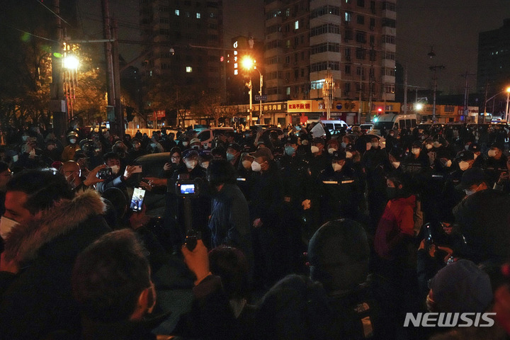 [베이징=AP/뉴시스] 27일 중국 베이징에서 코로나19 봉쇄 정책에 항의하는 시위대가 경찰과 대치하고 있다. 시민들은 정부에 항의하는 의미를 담은 ‘백지’를 들고 28일 새벽까지 시위를 이어갔다. 2022.11.28.