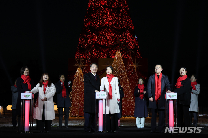 [서울=뉴시스] 홍효식 기자 = 윤석열 대통령과 부인 김건희 여사가 16일 서울 종로구 열린송현광장에서 열린 윈·윈터 페스티벌 개막식에 입장하며 트리 점등 버튼을 누르고 있다. (대통령실통신사진기자단) 2022.12.16. yesphoto@newsis.com