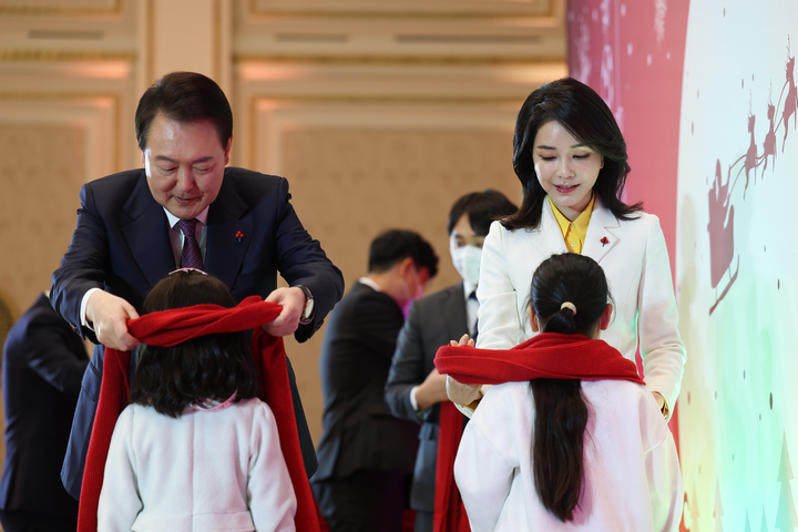 [서울=뉴시스] 윤석열 대통령과 부인 김건희 여사가 23일 청와대 영빈관에서 열린 보호아동·자립준비청년과 함께하는 크리스마스 행사에서 어린이들에게 목도리를 매주고 있다. (사진=대통령실 제공) 2022.12.23. photo@newsis.com *재판매 및 DB 금지