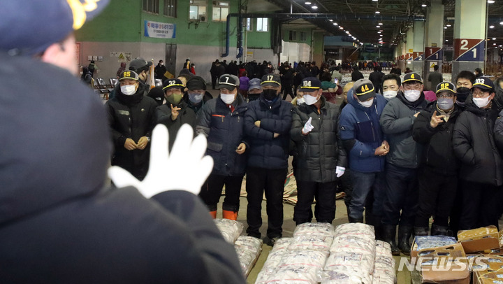 [부산=뉴시스] 하경민 기자 = 2023년(계묘년) 초매식이 열린 2일 오전 부산 서구 부산공동어시장에서 중도매인들이 힘찬 손짓으로 새해 첫 수산물 경매를 진행하고 있다. 부산공동어시장은 코로나19 여파로 3년 만에 초매식과 풍어기원제를 개최했다. 2023.01.02. yulnetphoto@newsis.com