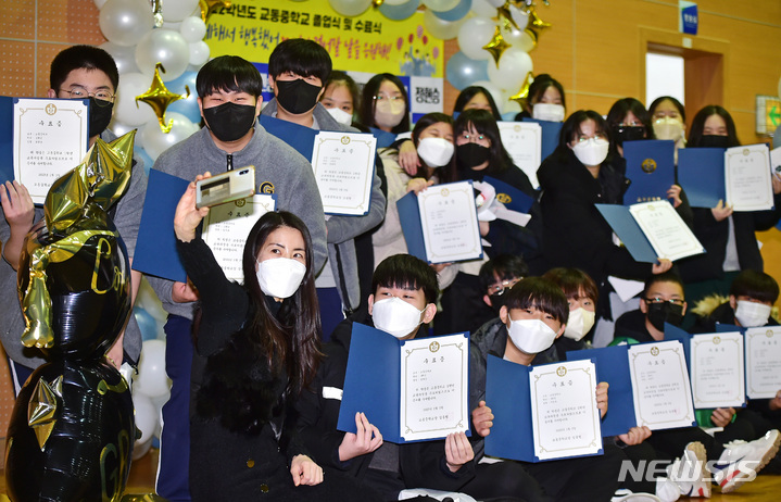 [대구=뉴시스] 이무열 기자= 지난 3일 대구 북구 교동중학교에서 열린 '제23회 교동중학교 졸업식 및 수료식'에서 1학년 2학년 재학생들이 선생님과 함께 기념사진을 찍고 있다. 2023.01.29. lmy@newsis.com