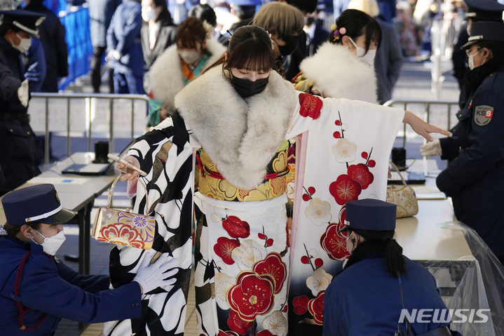 [요코하마=AP/뉴시스] 기모노 차림의 여성들이 9일 도쿄 인근 요코하마에서 20세가 된 것을 축하하는 성년의 날 공식 행사에 참석하기 위해 보안 검색을 받고 있다. 일본의 각 지방 자치 단체는 매년 1월 둘째 주 월요일마다 성인이 된 청년들을 축하하는 행사를 개최한다. 일본은 2022년 성인의 나이를 20세에서 18세로 낮췄다. 2023.01.09.