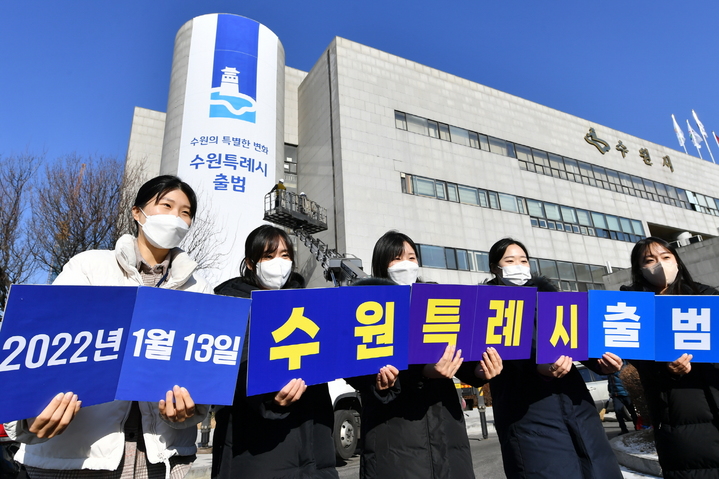 [수원=뉴시스] 지난해 1월 특례시 출범을 앞두고 수원시청에 대형 현수막이 게시된 가운데 수원시 직원들이 특례시 출범을 축하하는 카드를 들고 있다. (사진=수원시 제공) 2023.01.10. photo@newsis.com *재판매 및 DB 금지