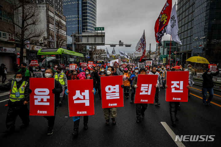 [서울=뉴시스] 정병혁 기자 = 14일 서울 중구 서울역 앞에서 촛불행동 '윤석열 퇴진, 김건희 특검' 1월 전국집중 촛불대행진 참석자들이 시청역 방향으로 행진하고 있다. 2023.01.14. jhope@newsis.com