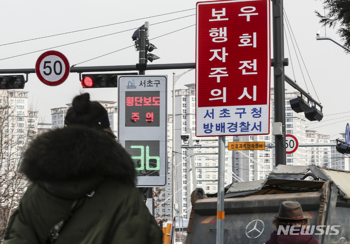 [서울=뉴시스] 김근수 기자 = 지난달 19일 오후 서울 서초구 반포대로 인근에 우회전 차량 주의 안내표지판이 설치돼 있다. 경찰청은 22일부터 우회전 신호등 신호를 위반하면 처벌되는 도로교통법 시행규칙이 시행된다고 밝혔다. 위반 시 도로교통법에 따라 20만원 이하의 벌금이나 30일 미만의 구류로 처벌될 수 있다. 2023.01.19. ks@newsis.com