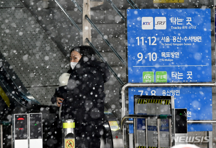 [광주=뉴시스] 이영주 기자 = 설 연휴 마지막 날인 24일 오전 광주 광산구 광주송정역에서 한 귀경객이 아이를 안고 에스컬레이터를 오르고 있다. 2023.01.24. leeyj2578@newsis.com