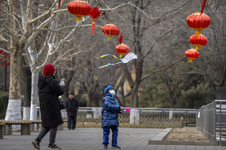 [베이징=AP/뉴시스]26일 중국 춘절 연휴 기간 동안 베이징의 한 공원에서 마스크를 쓴 소년이 연을 날리고 있다.&nbsp; *재판매 및 DB 금지