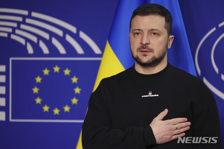 [AP/뉴시스] 젤렌스키 우크라이나 대통령이 9일 브뤼셀 유럽의회 연설에 앞서 자국 국기에 경례하고 있다. 